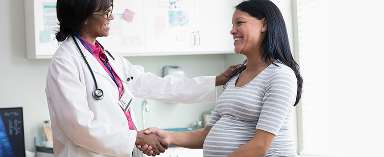 Pregnant woman talking to doctor.
